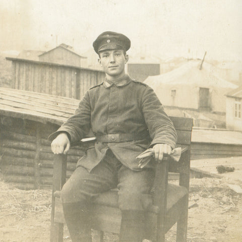 World War I German Soldier Seated Outdoor in Military Camp Photo Postcard